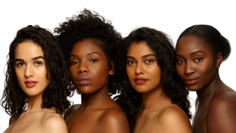An image of several different brown and Black women standing in a row.