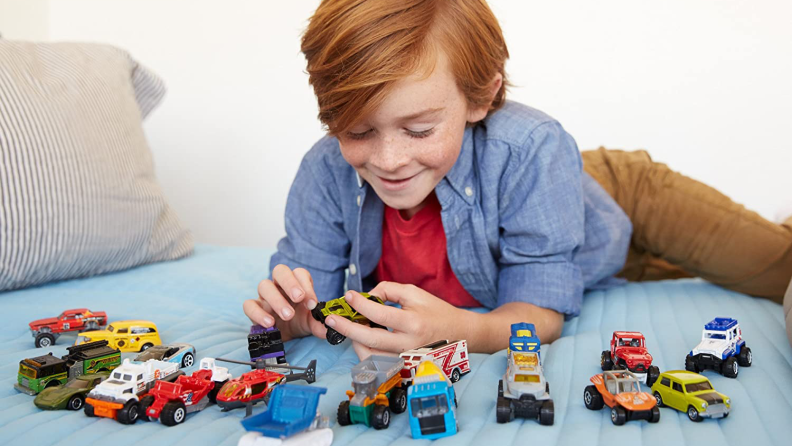 Little boy playing with Matchbox cars