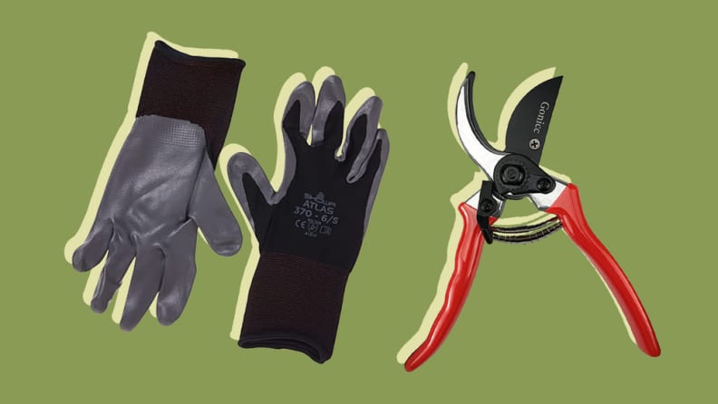 Two grey-black gardening gloves next to a pruning shears.
