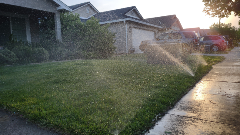 Sprinkler system sprays grass