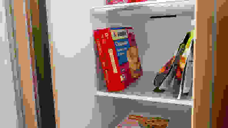 A close-up of the Samsung RS27T5561SR side-by-side refrigerator's freezer shelves, with some common items stored there for scale. A box of breakfast sandwiches standing tall takes up about 80% of the shelf's height.