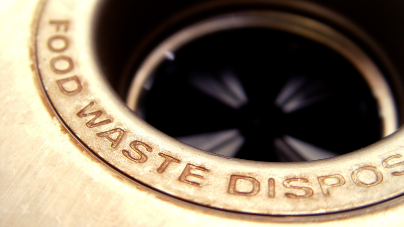 Close up of a garbage disposal in a sink.