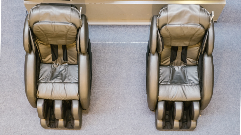Two tan massage chairs sitting next to each other shot from an overhead angle