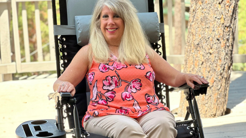 Person smiling while sitting in the Best Choice Products Oversized Padded Zero Gravity Chair with arms on both armrests.