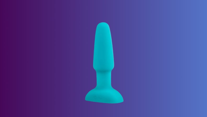 An anal sex toy sits on an indigo fade background
