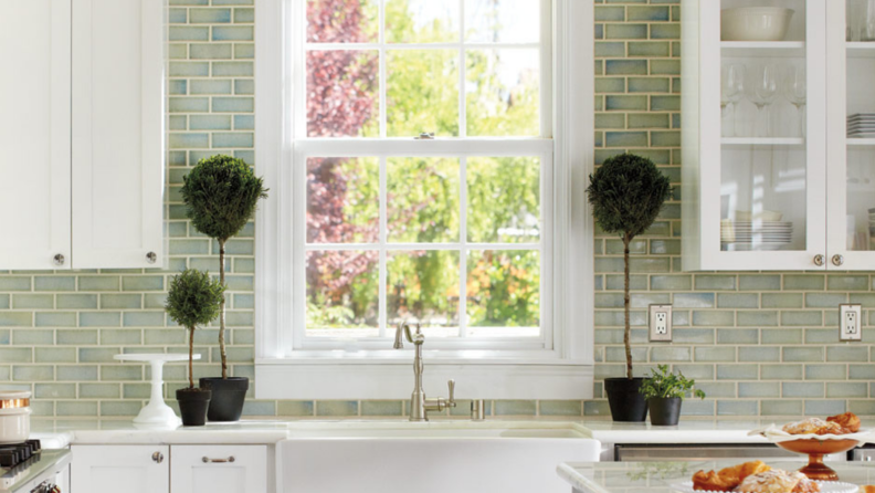 A subway tile backsplash that goes up to the ceiling