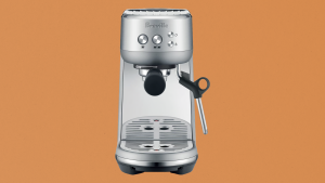 Breville Bambino espresso maker on brown paper-like background
