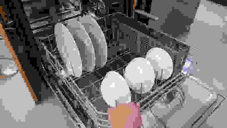 Close up of a bottom rack inside a dishwasher.