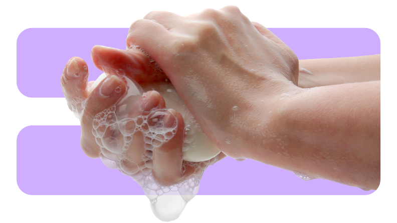 Person washing their hands with a bar of soap.