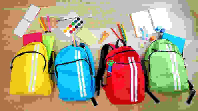 Four backpacks filled with school supplies