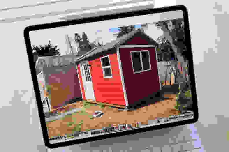 A close-up of the iPad Pro's display, which is showing an image of a small red shed with a white door.