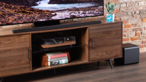 The Samsung HW-S800D Soundbar placed on top of a TV table and right below a flatscreen.