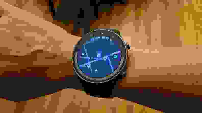 A hand with the watch on its wrist displaying general directions in Google Maps.