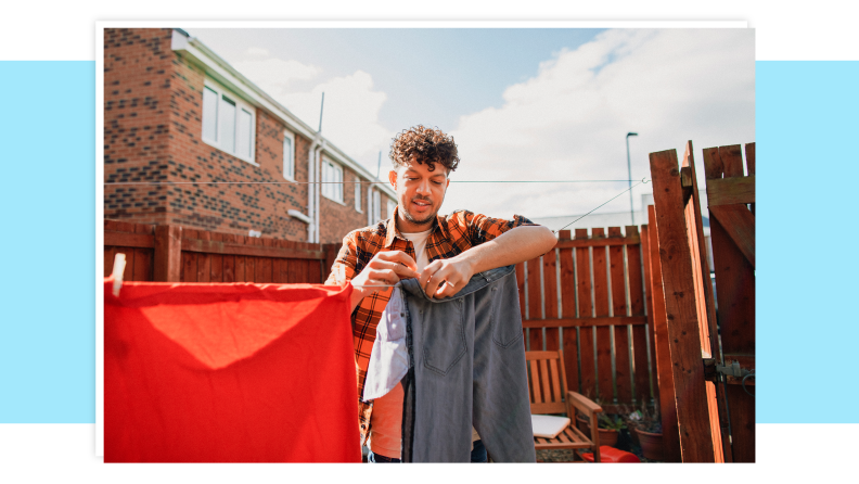 A person hanging up laundry on an outdoor clothes line