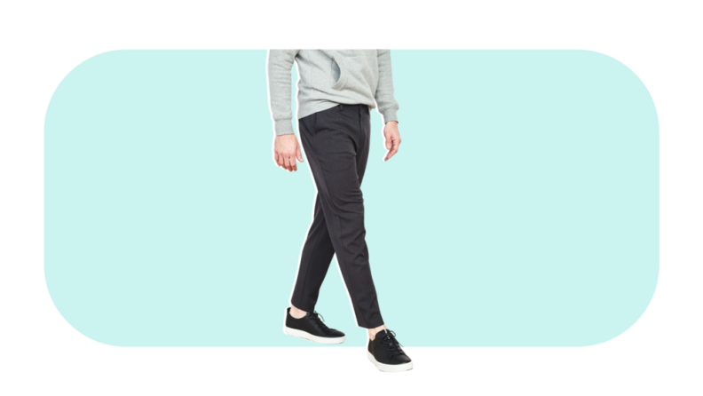 A male model wearing charcoal gray pants.
