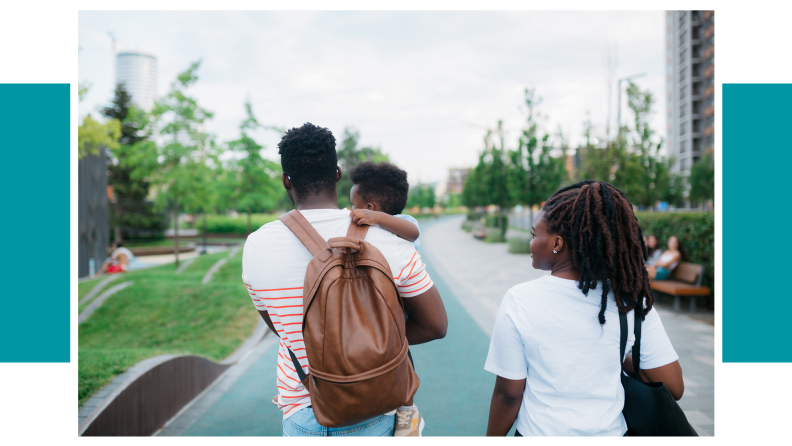 Two parents carrying a toddler