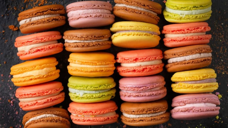 Four rows of colorful French macarons shot from above