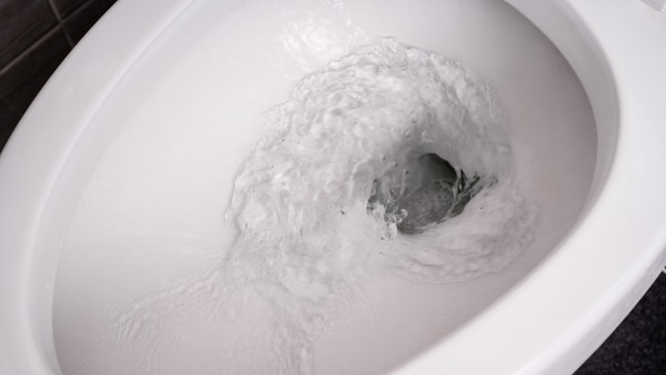 Water flushing down a toilet bowl