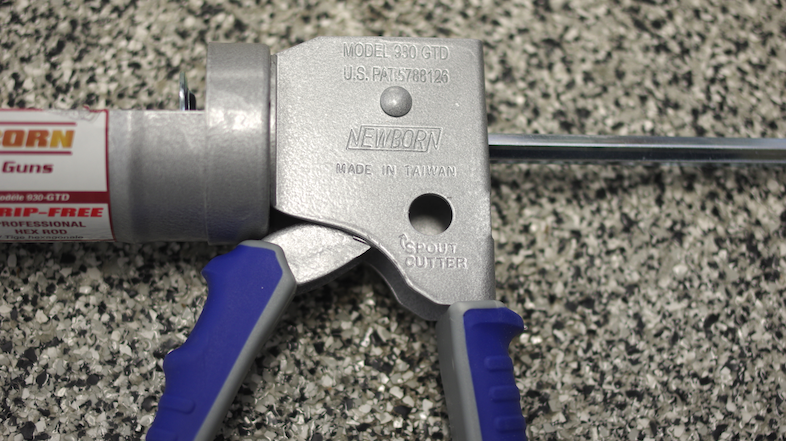 A caulk gun has a cutter that will open caulk tubes.