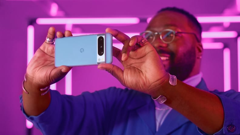 A man taking a photo with the Google Pixel 8 Pro smart phone.