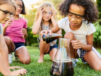 Girls conducting a science experiment in their backyard