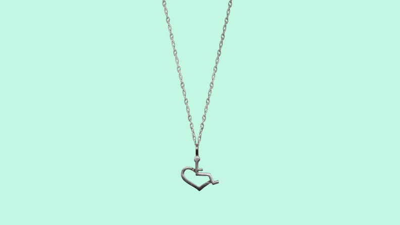The 3E Love necklace on a green background.
