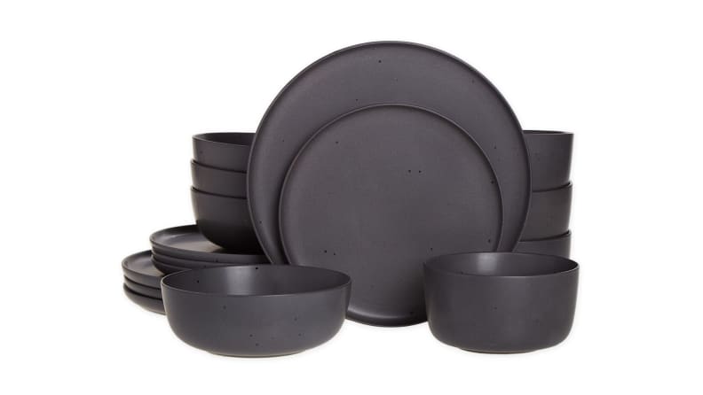 A set of dark grey matte dinnerware arranged on a white background.