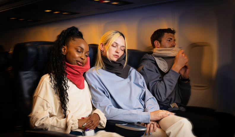 Passengers on a flight relaxing in Trtl Travel Pillows