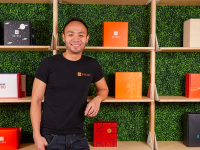 Danny Taing poses in front of Bokksu boxes