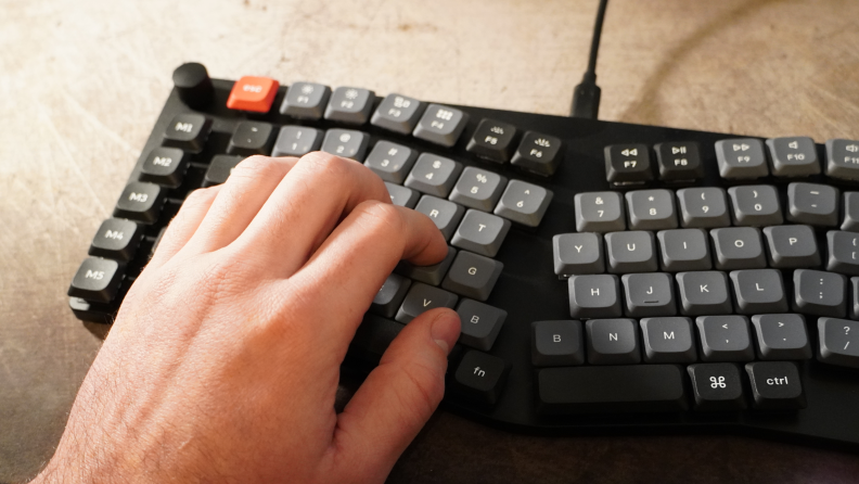 A person typing on the Keychron K15 Pro keyboard.
