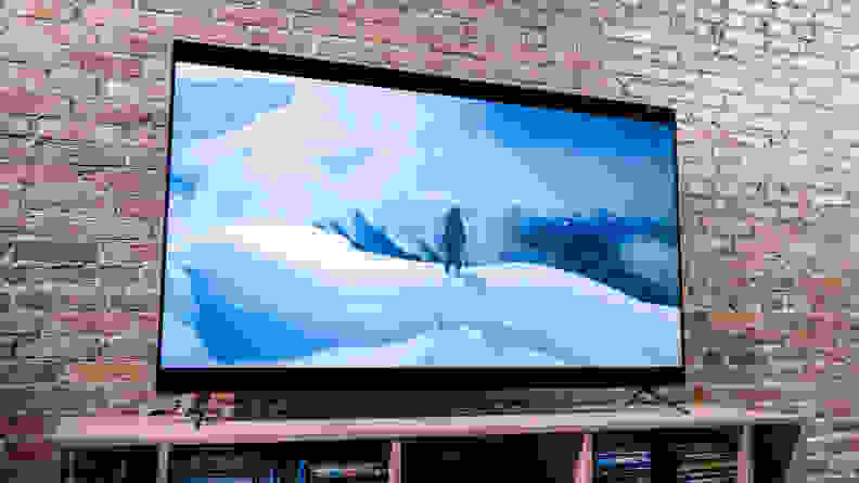 On a Vizio TV screen, a fictional astronaut climbs a snowy mountain on an alien world.