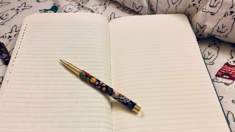 a journal lies open on a bed