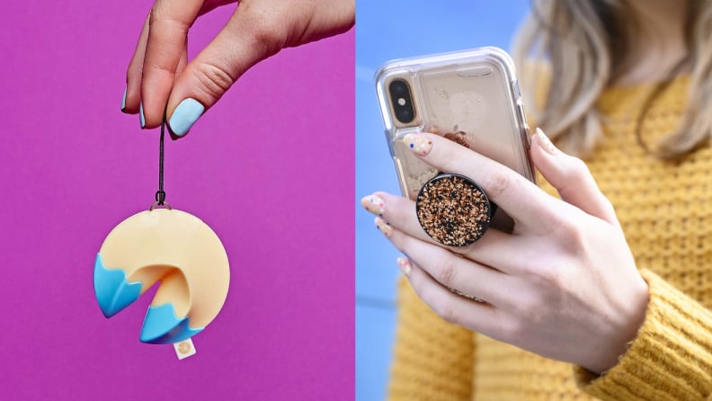 A fortune cookie bracelet and a person holding a phone with a popsocket.