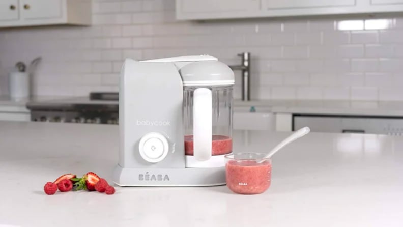 An image of a baby food maker seen from the side, on a countertop.