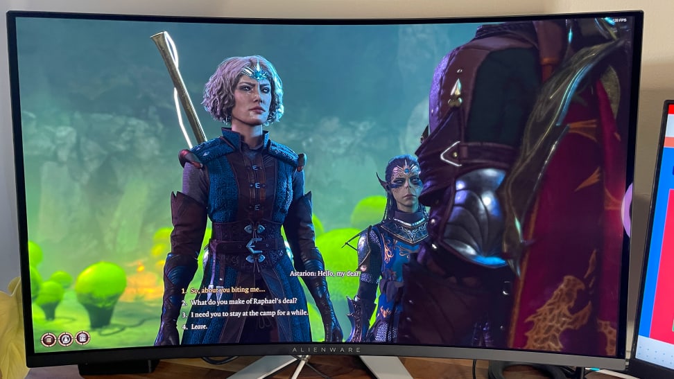 A half-elf talking to a vampire in Baldur's Gate 3 on screen of the Alienware AW3225QF monitor.