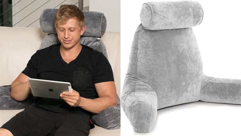 A person reads an iPad while lounging on a reading pillow.