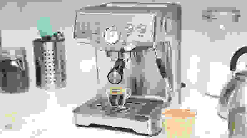 A silver espresso machine on a kitchen counter.