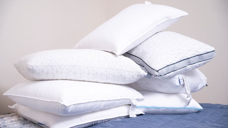 pile of several bed pillows