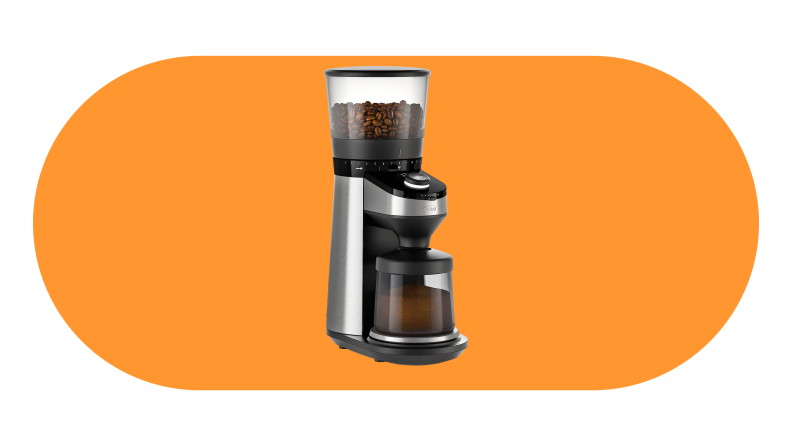 The OXO Brew Conical Burr Coffee Grinder against an orange background.