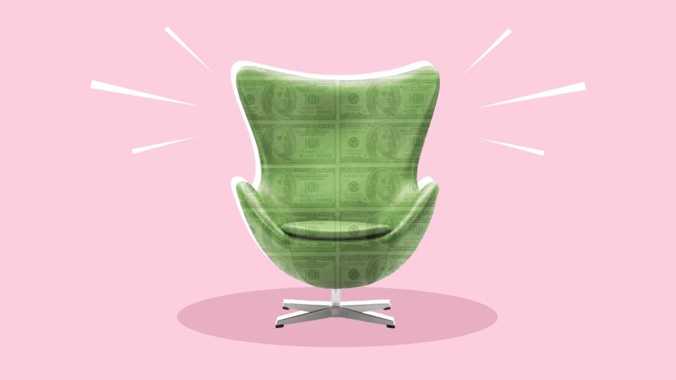 An egg chair with dollar bills overlaying it against a pink background.