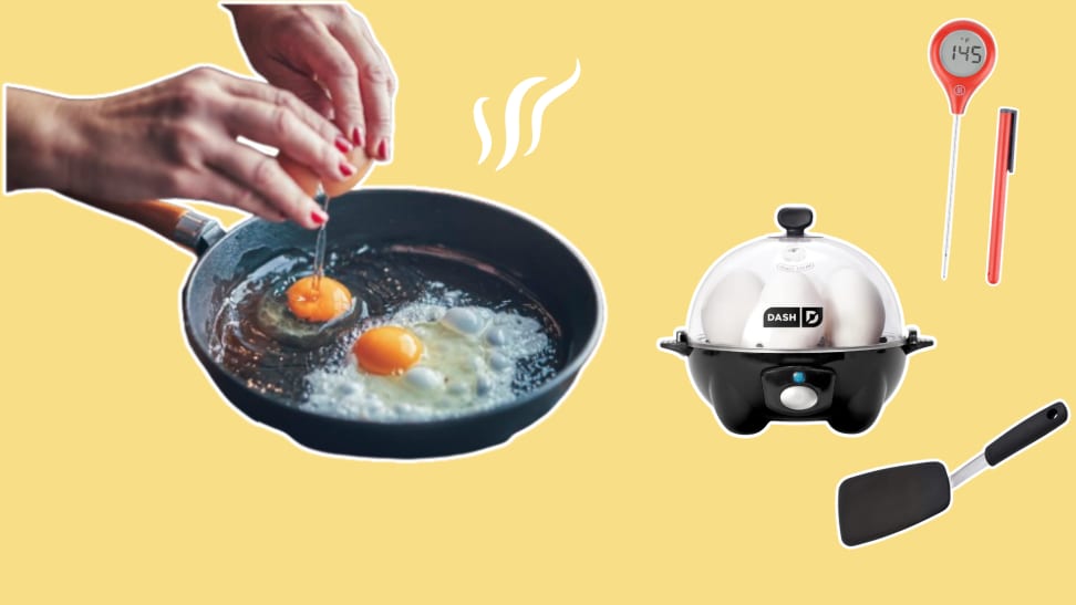 Hands cracking an egg into a skillet, digital thermometer, egg cooker, and spatula on yellow background