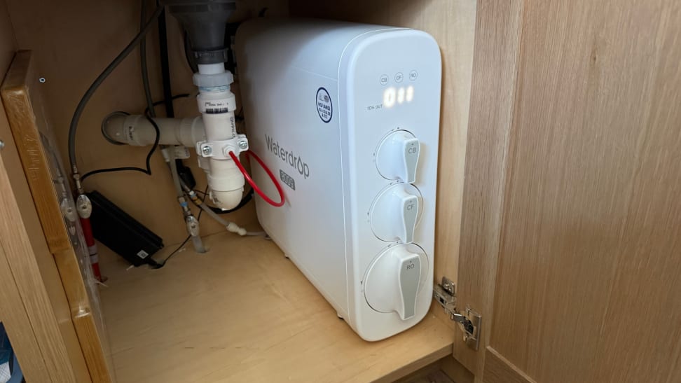 Waterdrop G3P800 reverse osmosis system installed under a kitchen sink with visible plumbing connections.