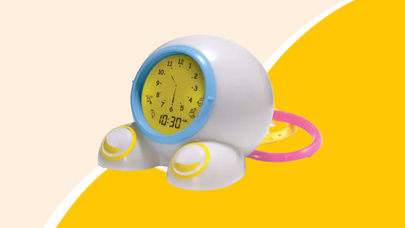 Small blue, pink and yellow circular alarm clock.