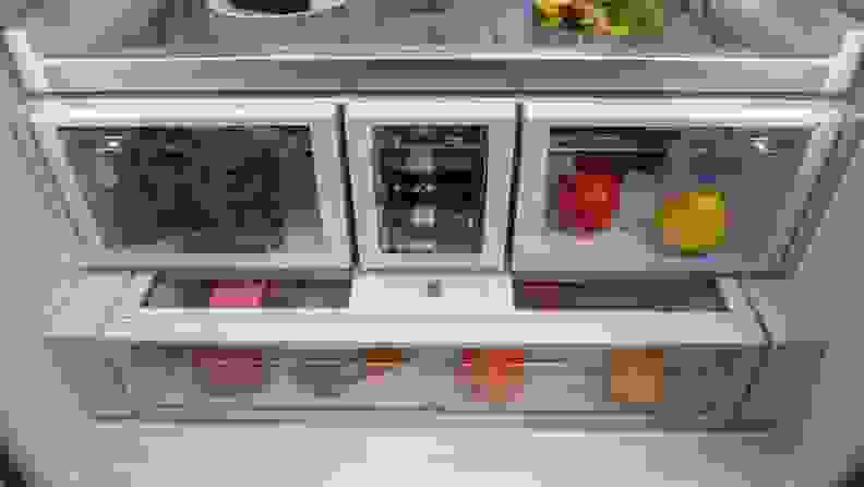 A close-up of the Whirlpool fridge compartment's lower half, showing its two crispers, beverage drawer, and full-width deli drawer.