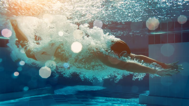 A man diving into a pool, photo is shot from underwater