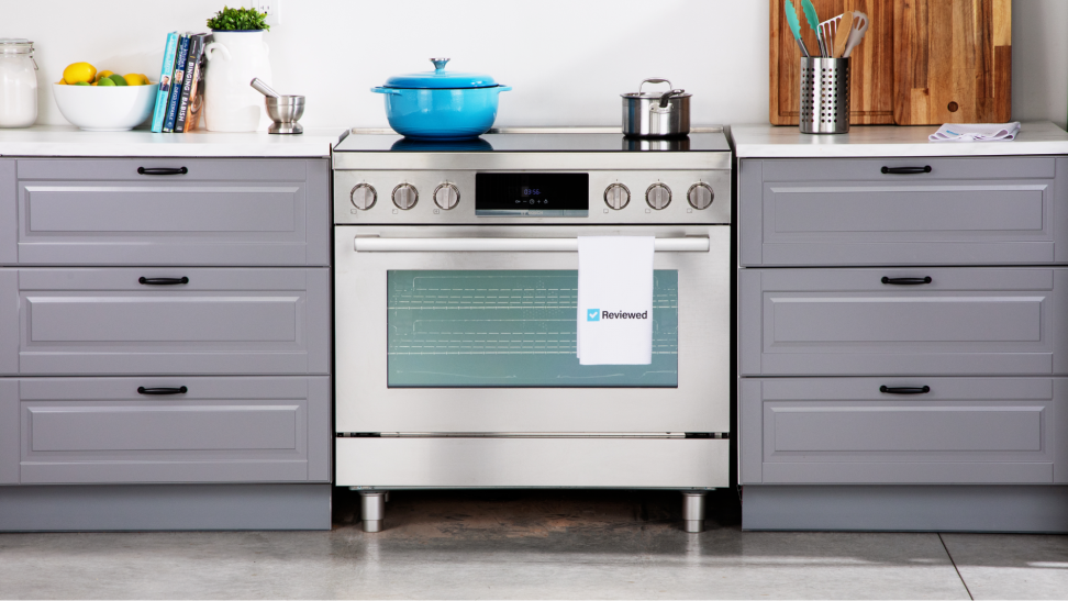 Bosch 36-inch induction range surrounded by gray countertops, topped with cookware