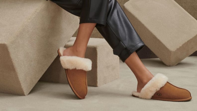 Person wearing comfortable fur-lined slippers.