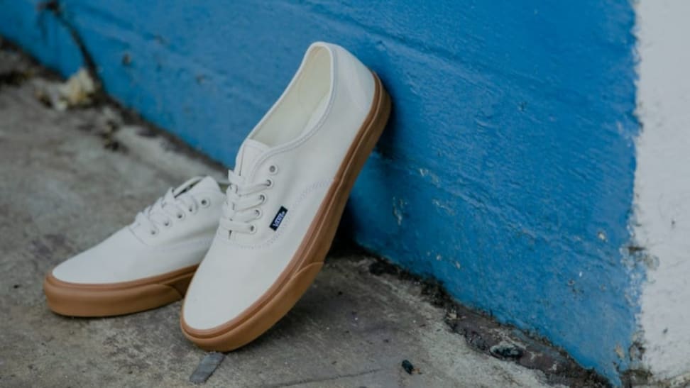 pair of white Vans canvas shoes with gum soles
