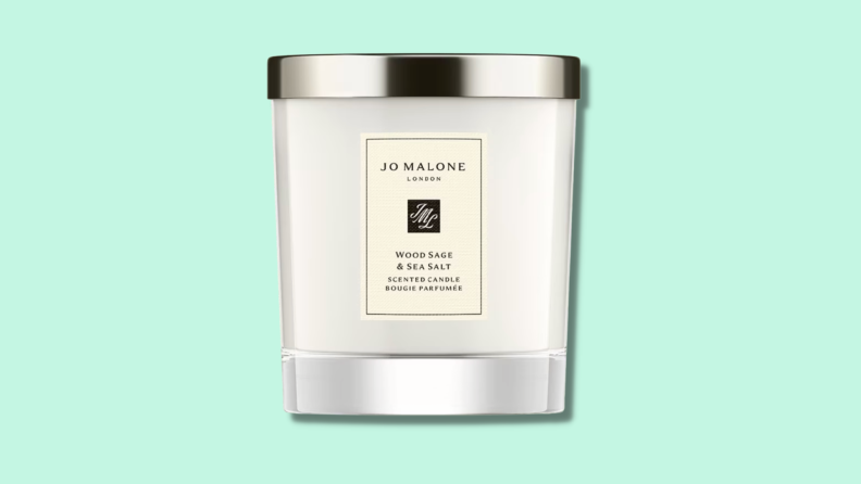 A Jo Malone candle against a green background.