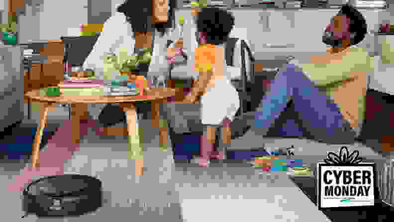 Image of family playing on the floor next to a robot vacuum